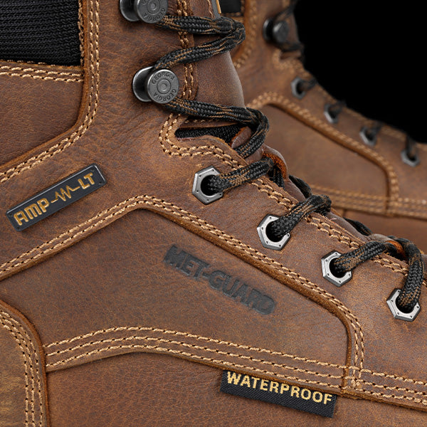 Close-up of brown leather boots with visible branding and waterproof label.