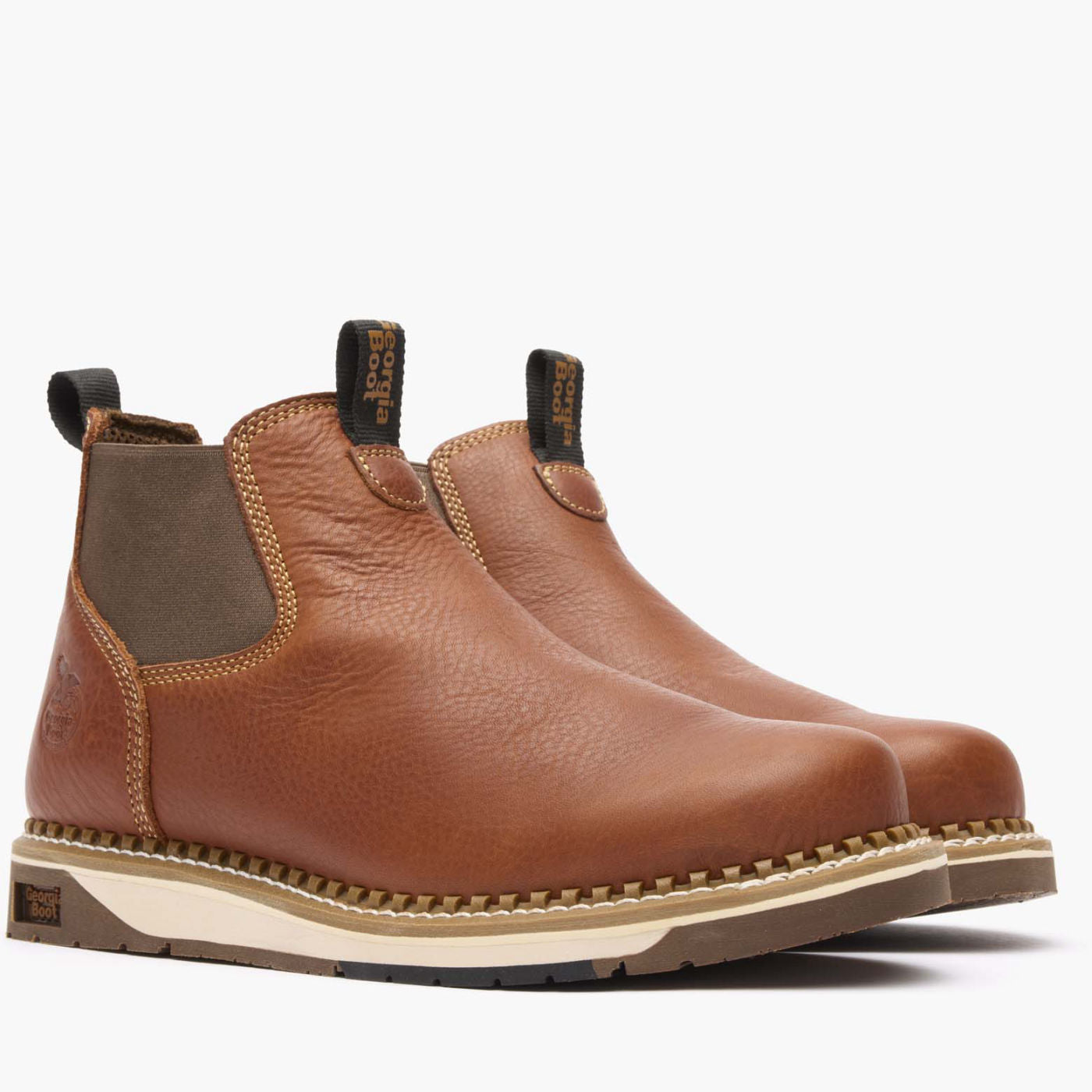 Pair of brown leather Chelsea boots on a white background