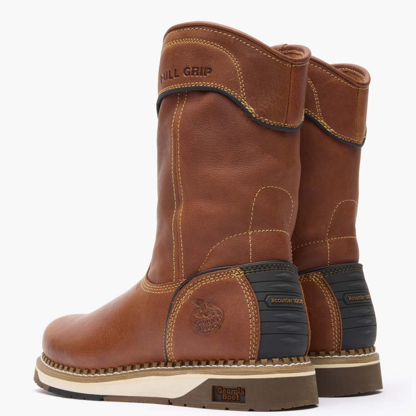 Pair of brown work boots with visible branding on a white background