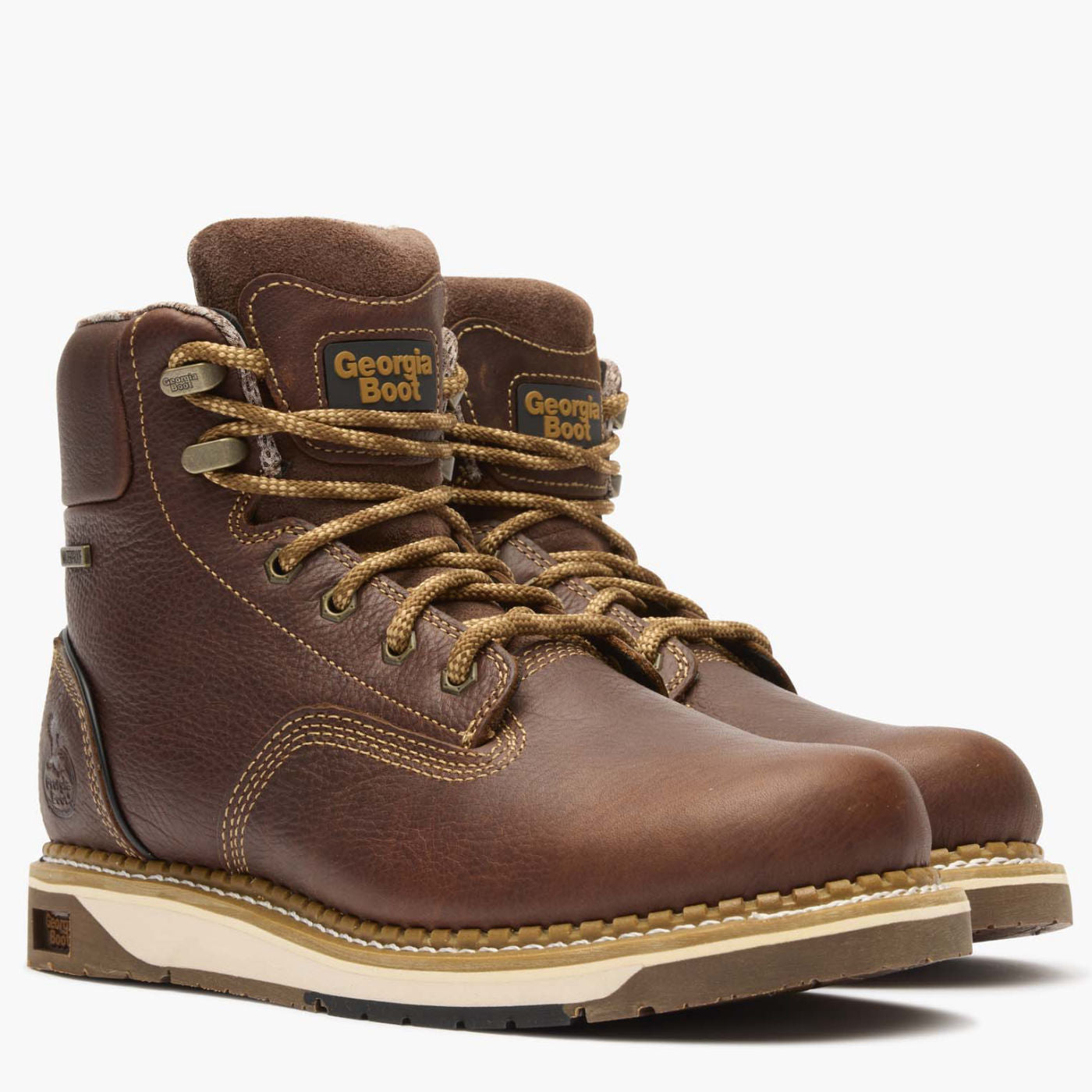 Pair of brown leather boots with laces on a white background