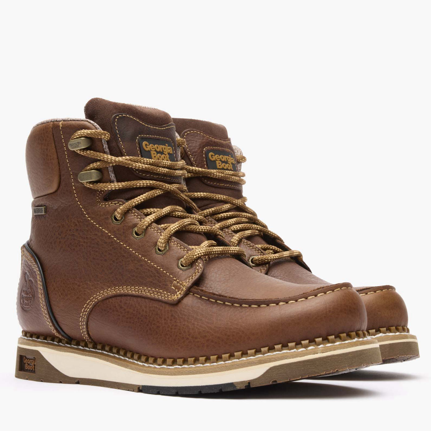 Pair of brown leather boots with laces on a white background