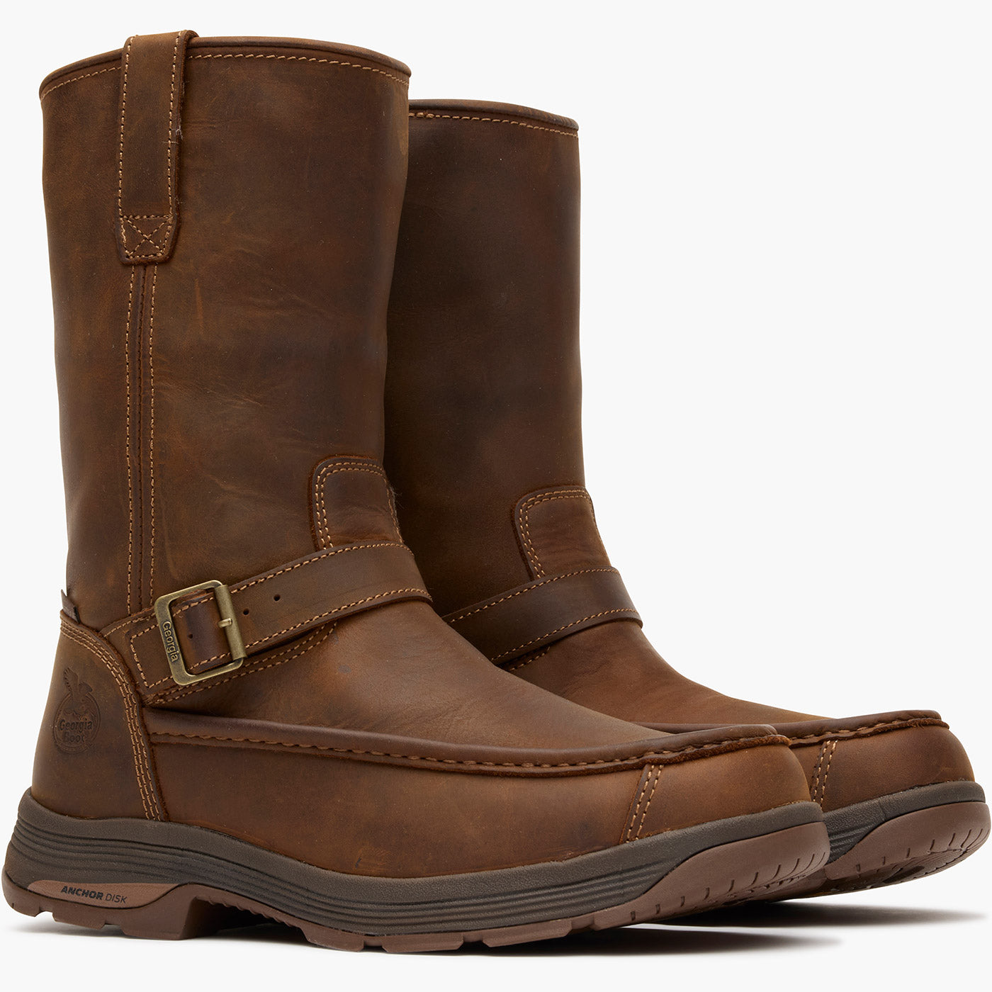 Pair of brown leather boots with a buckle on a white background