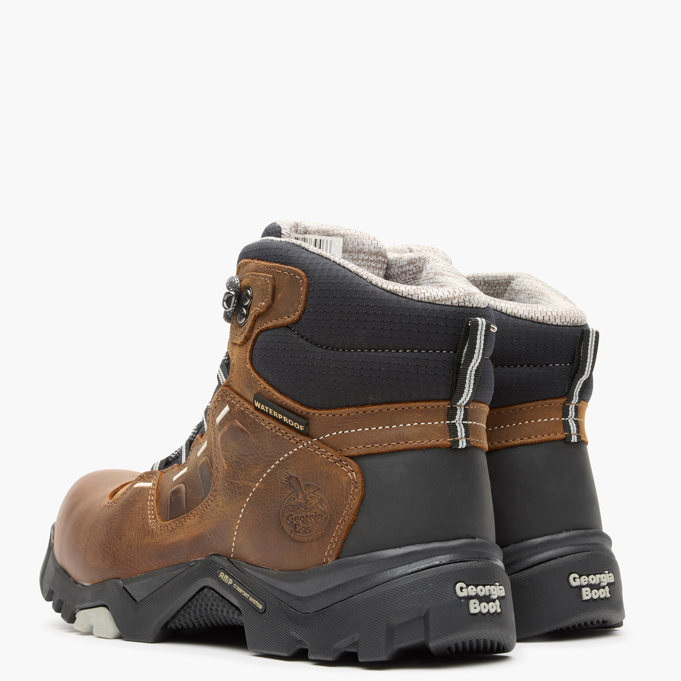 Pair of brown and black boots with visible branding on a white background