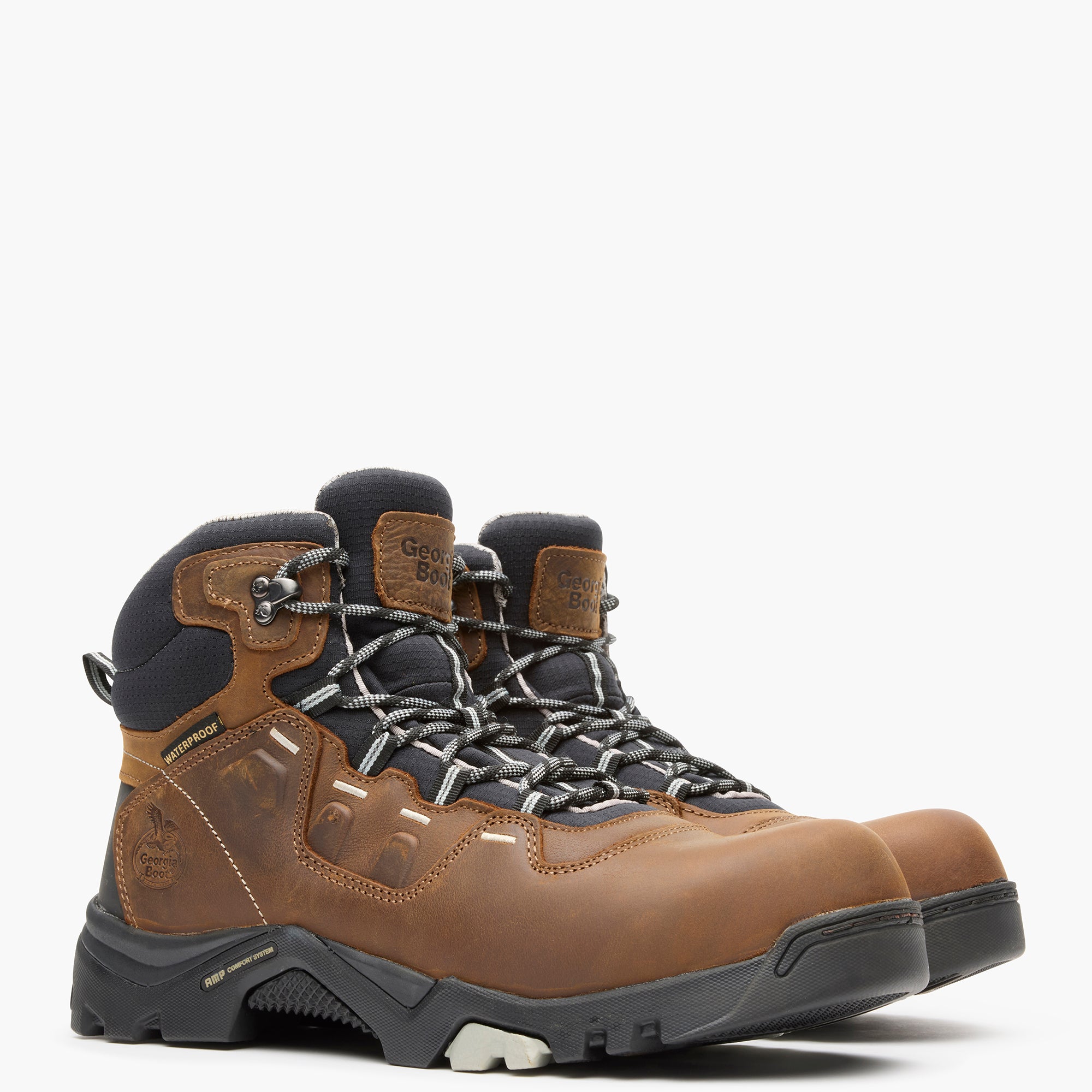 Brown hiking boots with black soles on a white background