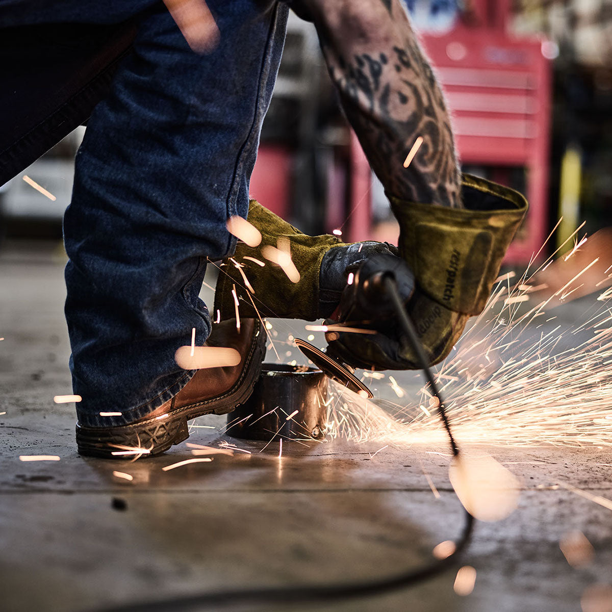 Person Using grinder wearing Georgia boots