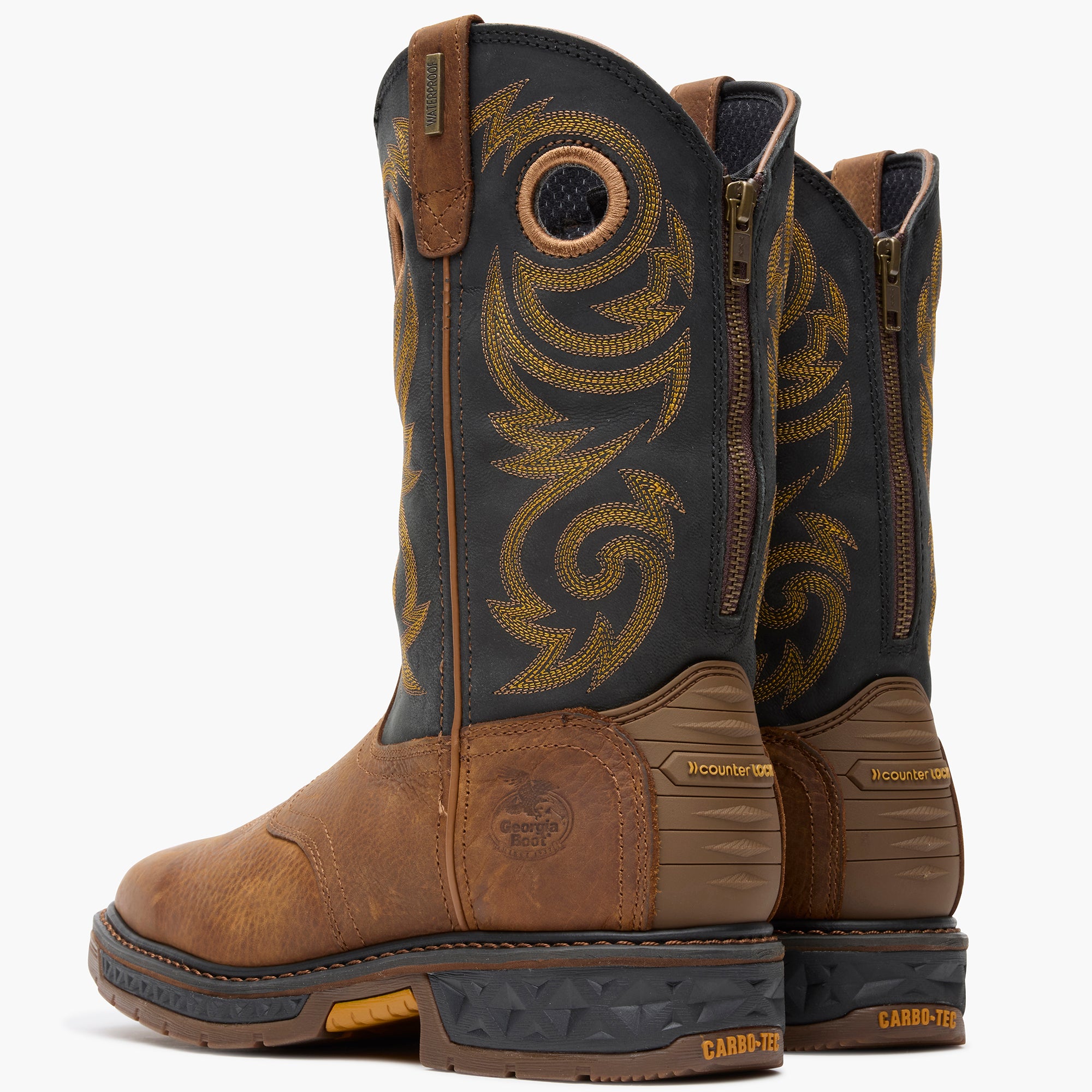 Pair of brown and black boots with intricate design on a white background