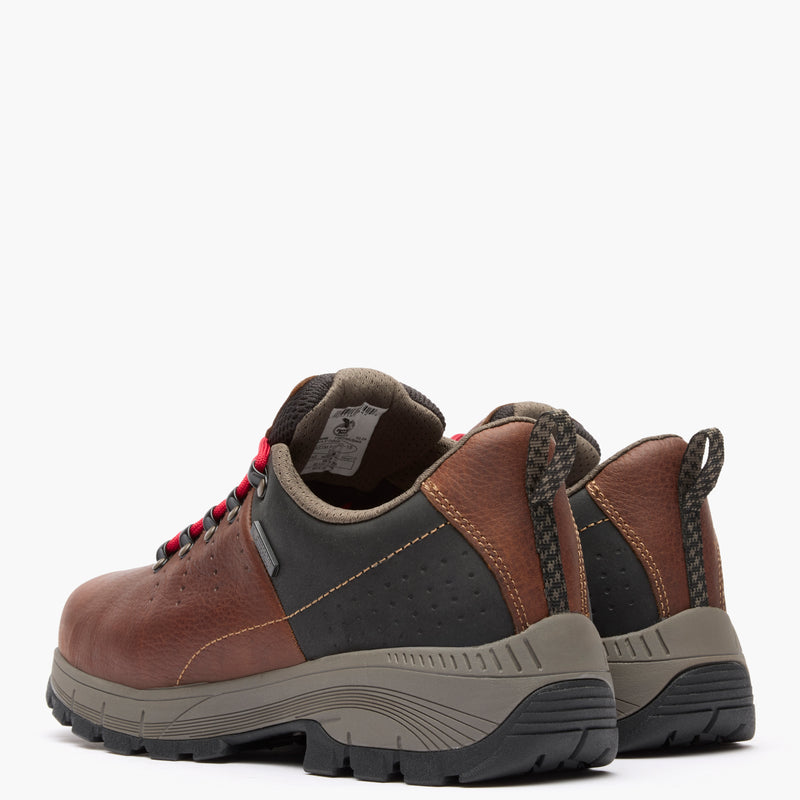 Pair of brown and black hiking boots on a white background