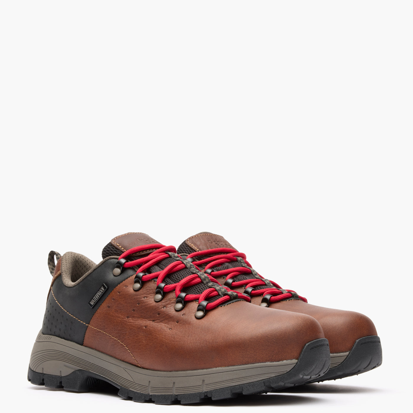 Brown hiking boots with red laces on a white background
